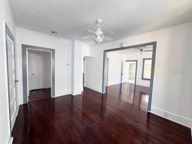 spare room with dark wood-type flooring and ceiling fan