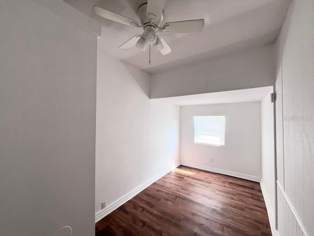 interior space featuring dark wood-type flooring and ceiling fan