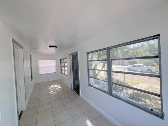 hall with light tile patterned flooring