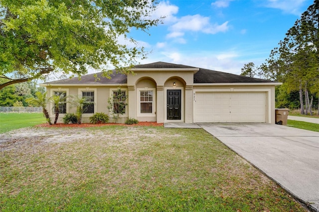 view of front facade with a garage and a front lawn