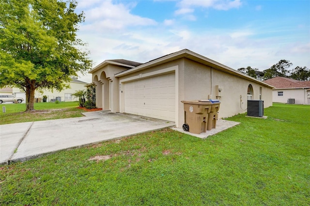 view of side of home with a garage, central AC, and a lawn