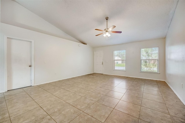 unfurnished room with ceiling fan, light tile floors, and lofted ceiling