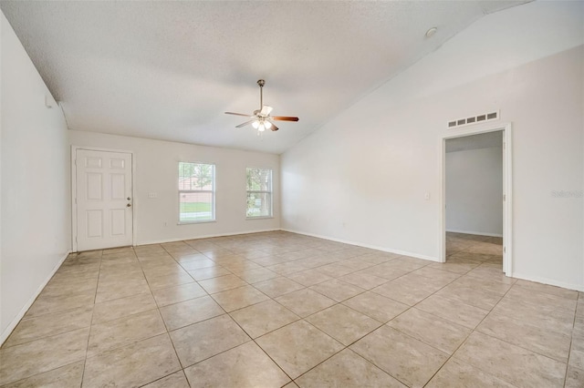 unfurnished room with ceiling fan, light tile floors, and lofted ceiling