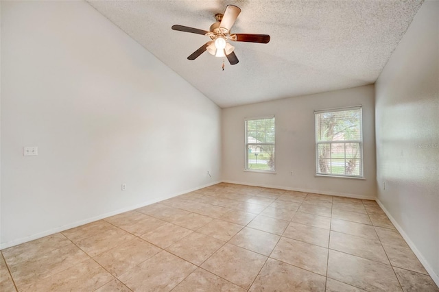 tiled empty room featuring ceiling fan, a textured ceiling, and lofted ceiling