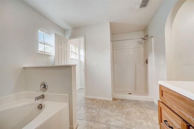 bathroom with vanity, shower with separate bathtub, and tile floors