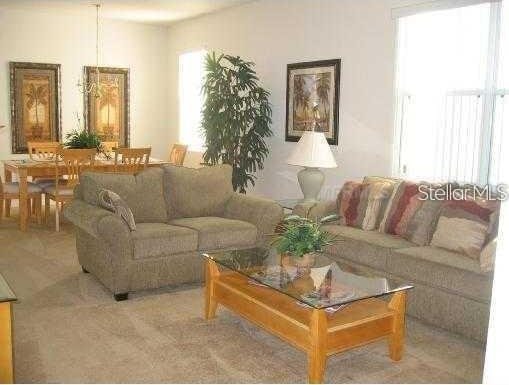 living room featuring light carpet