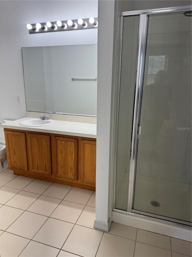 bathroom with tile patterned flooring, vanity, toilet, and walk in shower