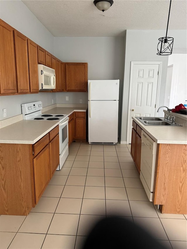 kitchen featuring white appliances, a textured ceiling, sink, pendant lighting, and light tile patterned floors