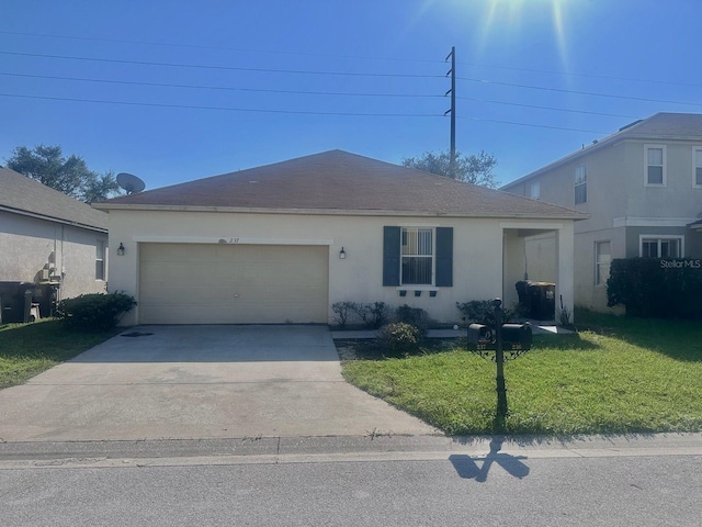 view of front of house featuring a front yard and a garage