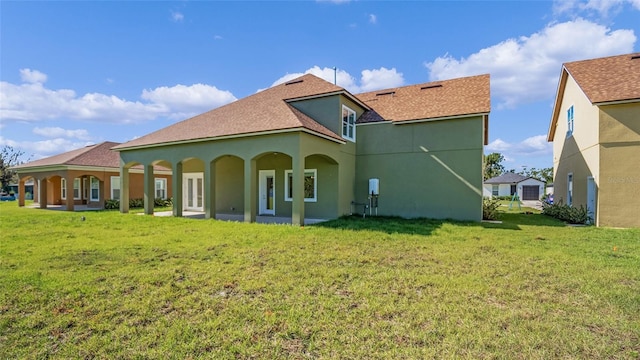 rear view of property featuring a yard