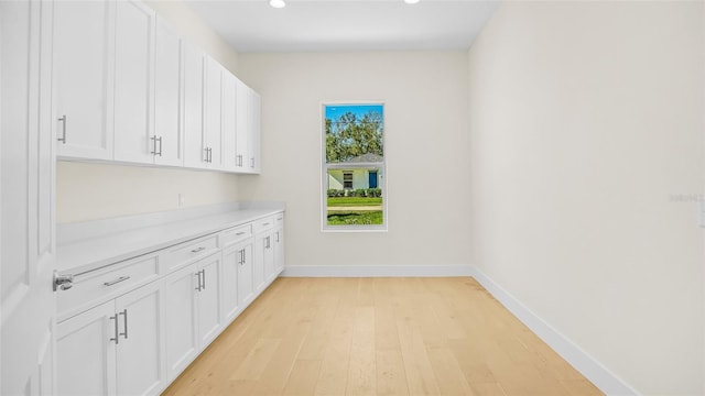 laundry room with light hardwood / wood-style flooring