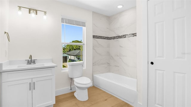 full bathroom with toilet, vanity, tiled shower / bath combo, and hardwood / wood-style flooring