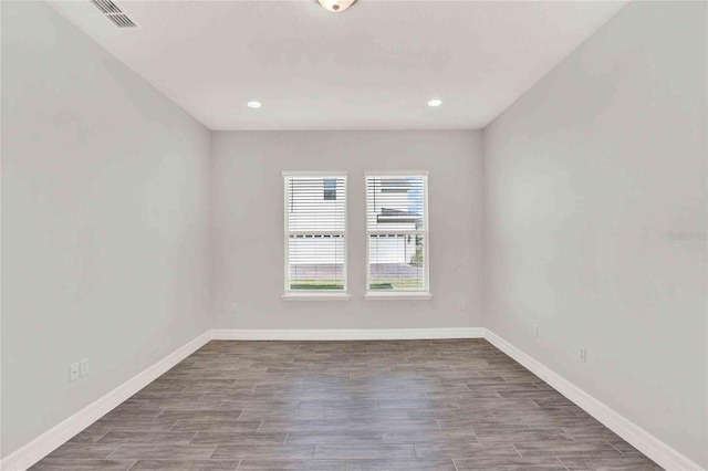 unfurnished room featuring dark hardwood / wood-style flooring