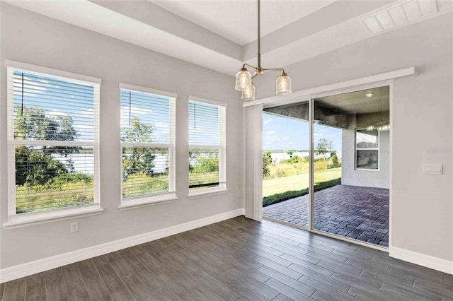 unfurnished dining area featuring dark hardwood / wood-style flooring and a notable chandelier