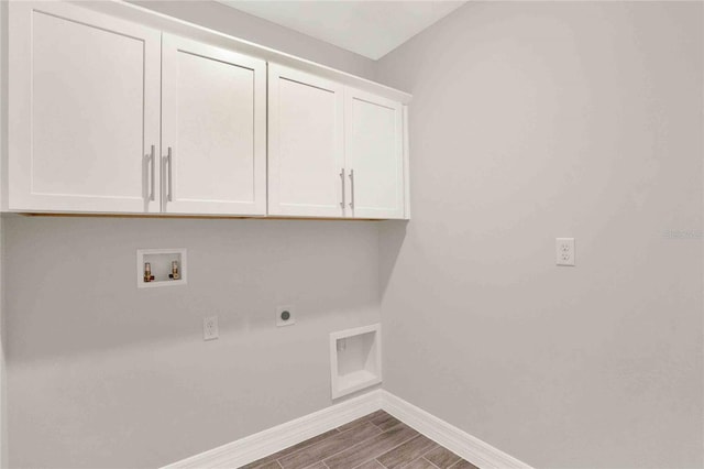 laundry room with hookup for a washing machine, cabinets, hookup for an electric dryer, and dark hardwood / wood-style floors