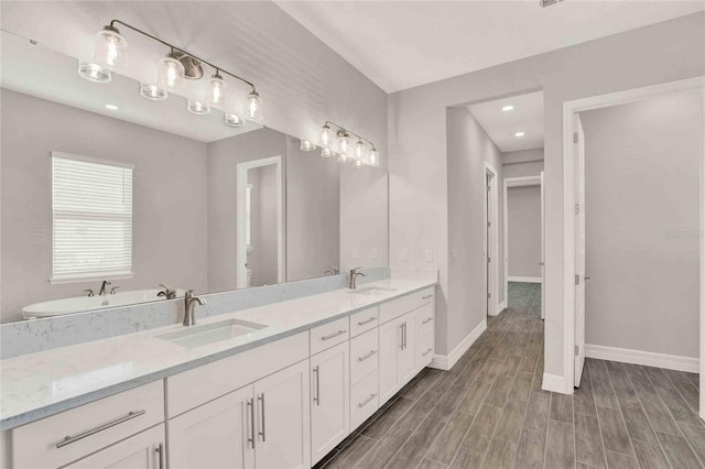 bathroom featuring wood-type flooring and dual vanity