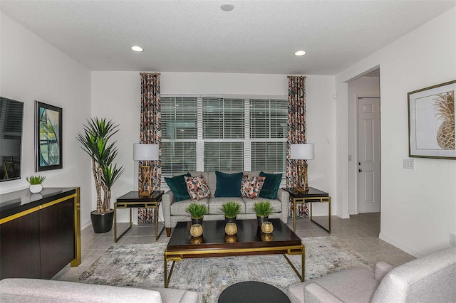 living room featuring light tile patterned floors and a textured ceiling