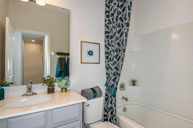 full bathroom with vanity, shower / bath combination with curtain, and toilet