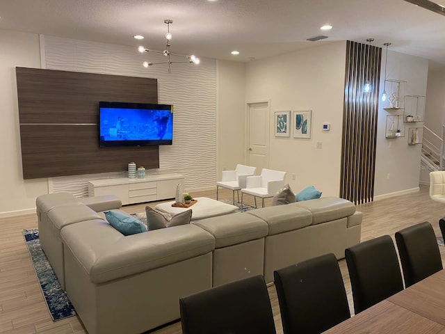 living room featuring light hardwood / wood-style flooring and a chandelier