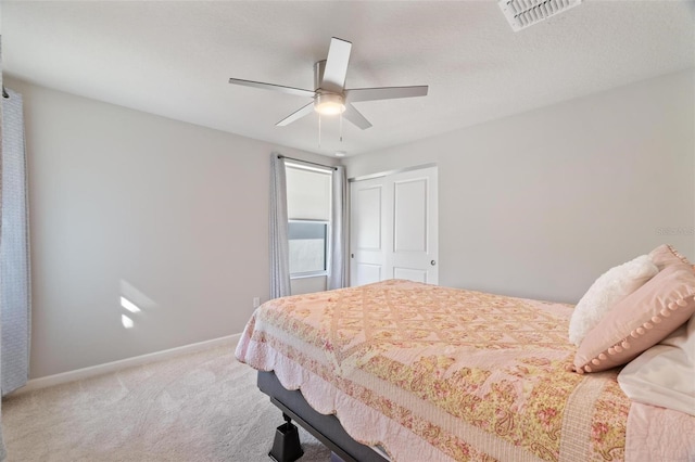 bedroom with light carpet, a closet, and ceiling fan