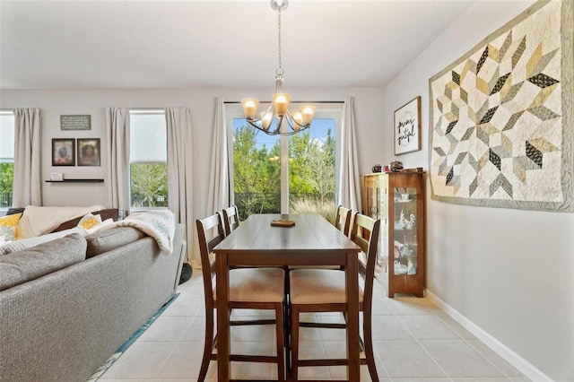 tiled dining area featuring a chandelier