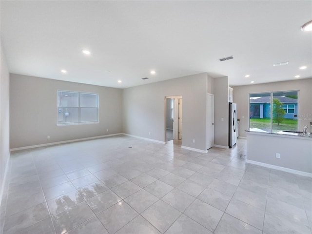 unfurnished room featuring light tile floors