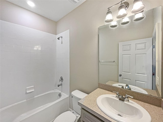 full bathroom with toilet, tiled shower / bath combo, and vanity