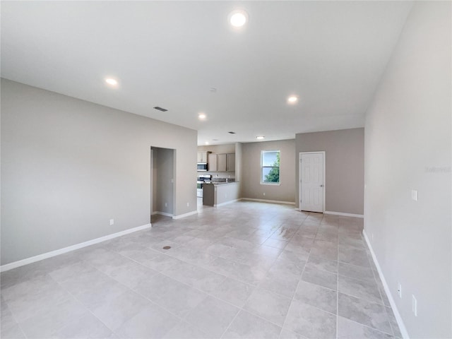 unfurnished living room featuring light tile flooring