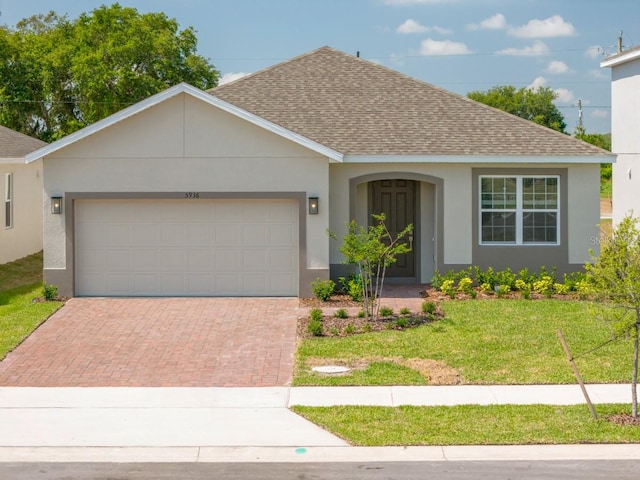 single story home with a front lawn and a garage