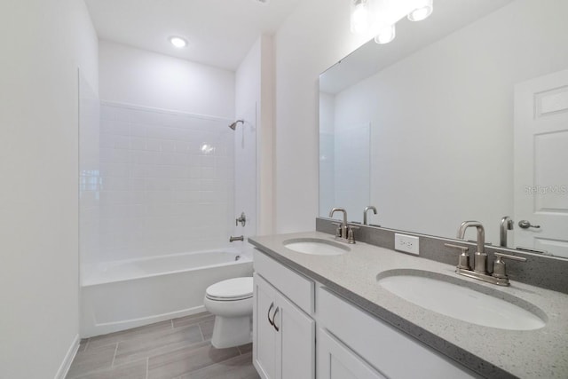 full bathroom featuring toilet, vanity with extensive cabinet space, tile flooring, double sink, and shower / washtub combination