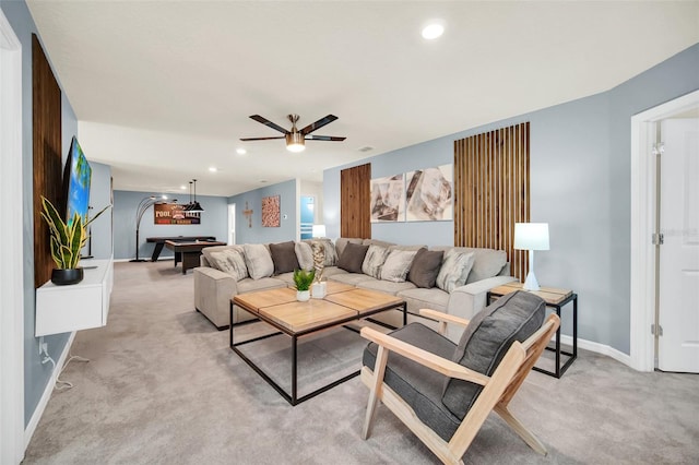 living room featuring ceiling fan, light colored carpet, and pool table