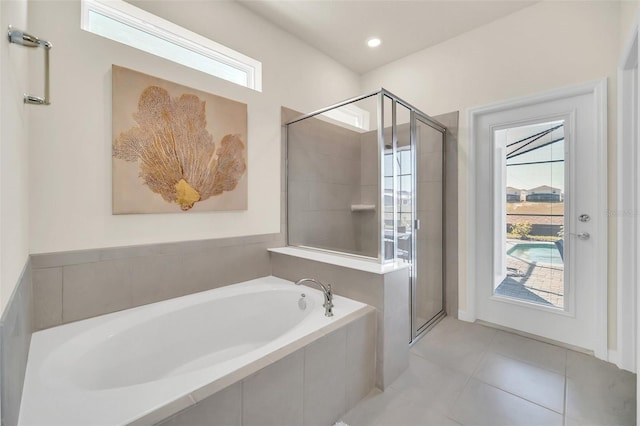 bathroom featuring tile patterned floors and separate shower and tub