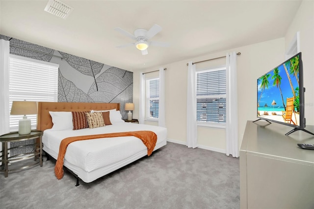 bedroom with ceiling fan, carpet flooring, and multiple windows