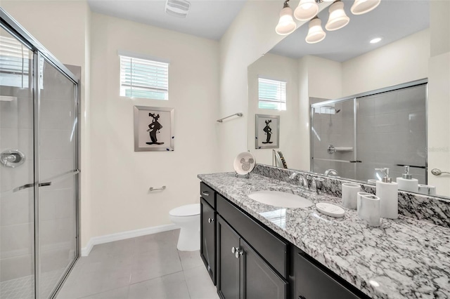 bathroom with vanity, toilet, a shower with shower door, and tile patterned flooring