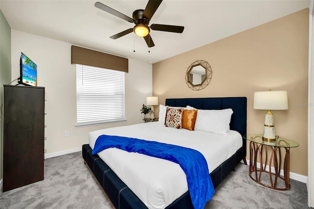 bedroom with ceiling fan and light carpet