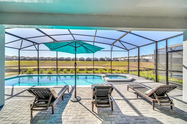 view of pool featuring an in ground hot tub, a lanai, and a patio area