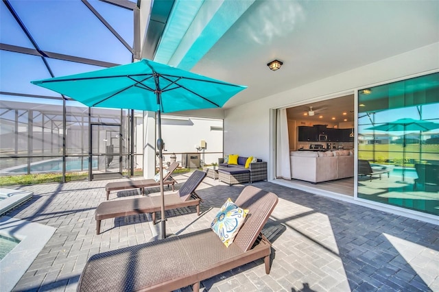 view of patio / terrace featuring outdoor lounge area and glass enclosure