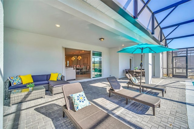 view of patio with an outdoor living space and a lanai