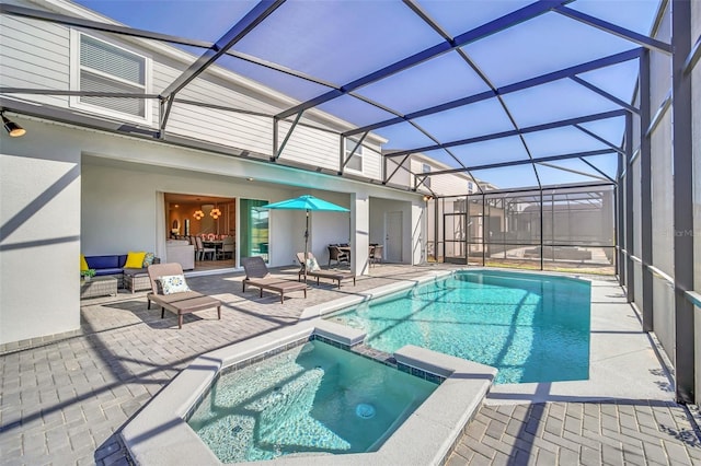 view of pool featuring a patio, glass enclosure, and an in ground hot tub