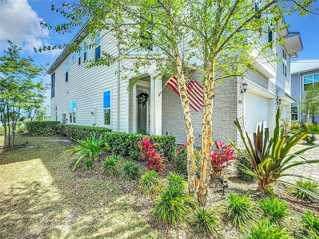 view of side of home featuring a garage