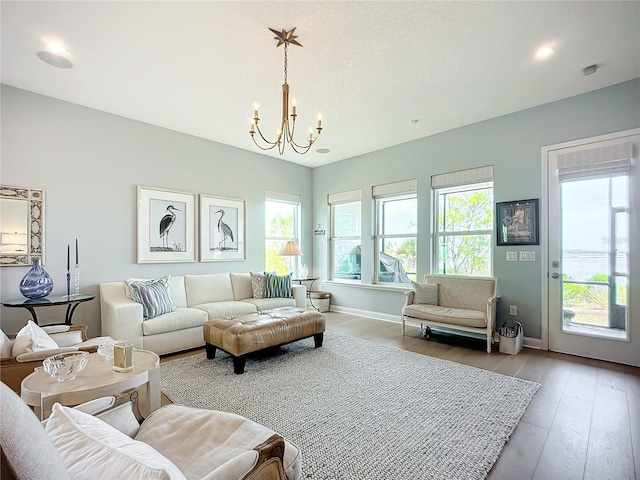 living room with hardwood / wood-style floors and a chandelier