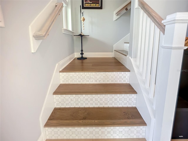 staircase with wood-type flooring