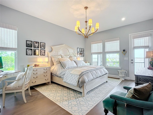 bedroom featuring a chandelier and hardwood / wood-style flooring