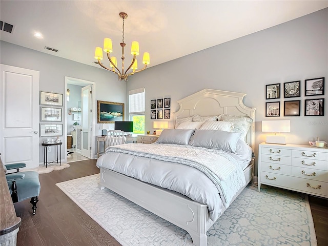 bedroom with an inviting chandelier and hardwood / wood-style floors