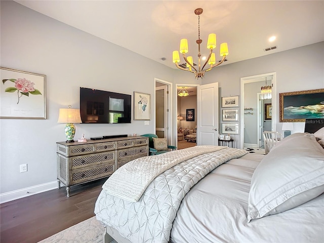 bedroom with dark hardwood / wood-style flooring and an inviting chandelier