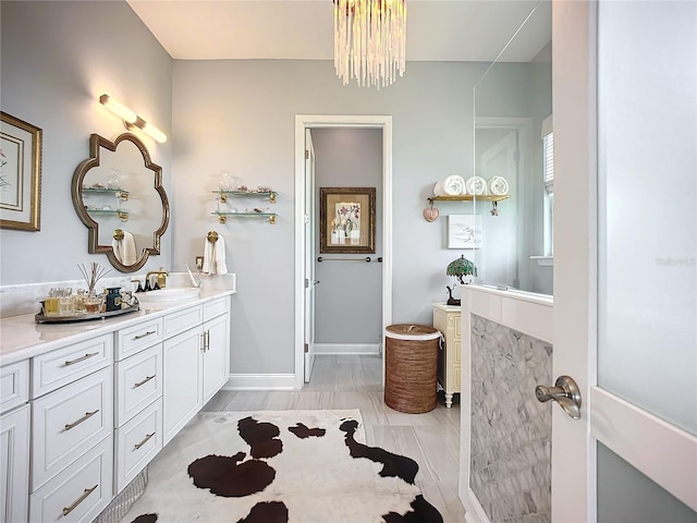 bathroom featuring a notable chandelier and vanity