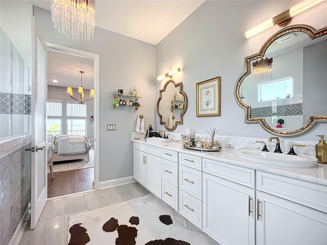 bathroom with vanity and a chandelier