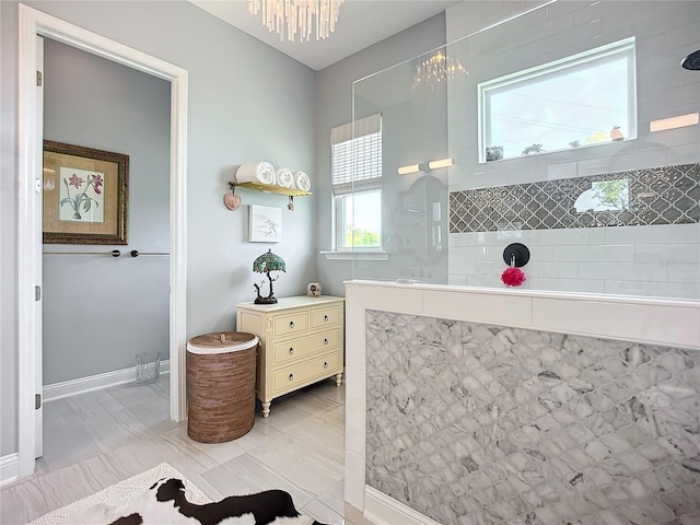 bathroom with a notable chandelier and a shower