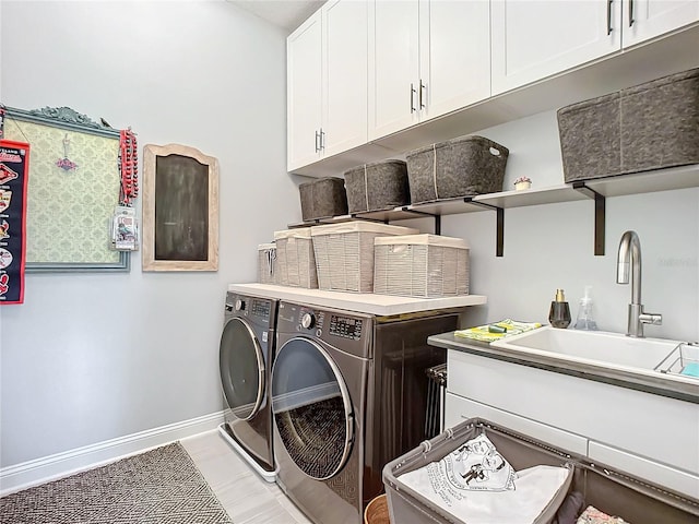 laundry area with sink, cabinets, and independent washer and dryer