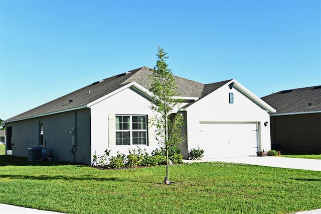 ranch-style home featuring central AC, a front lawn, and a garage